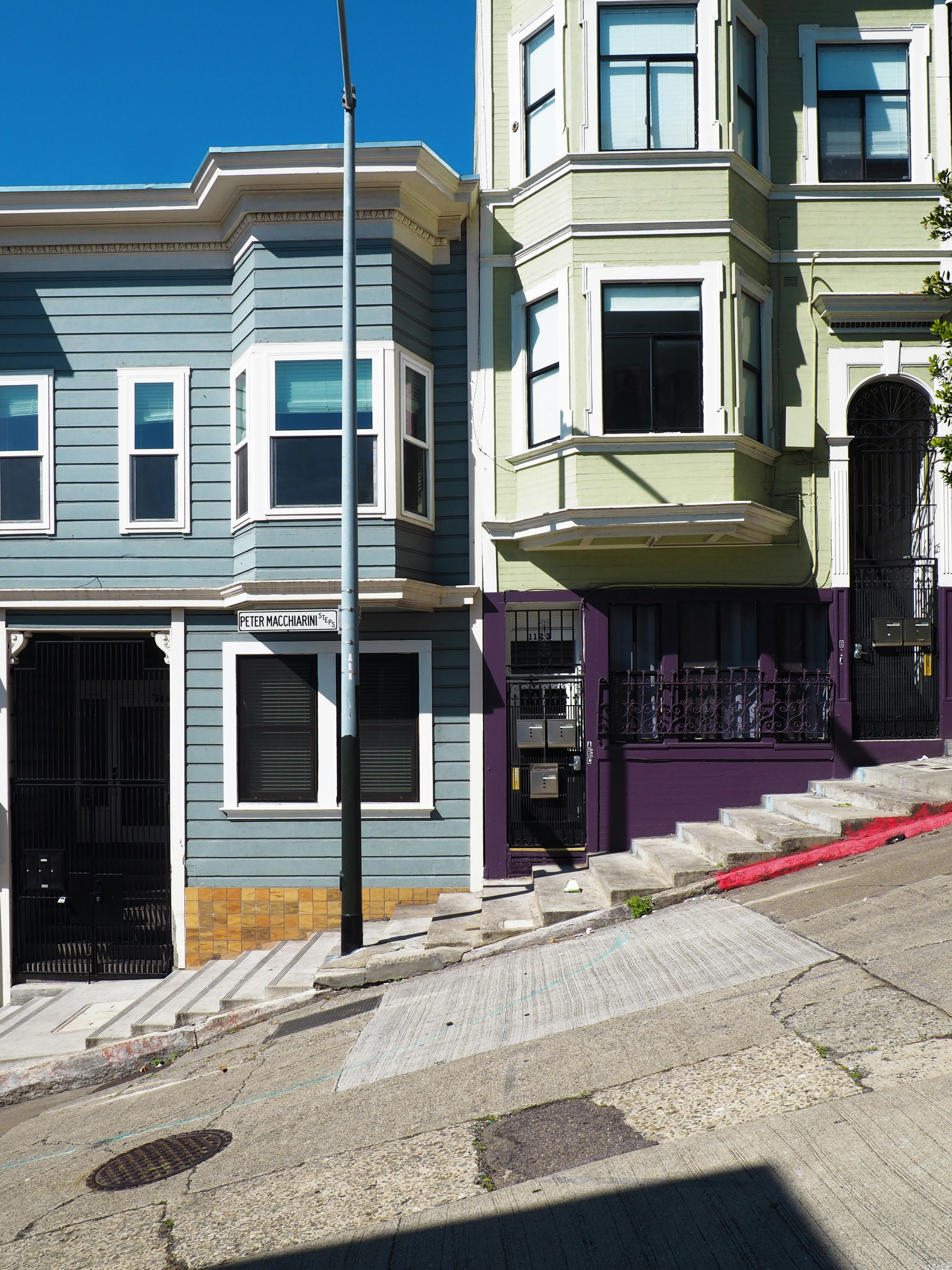 white and blue concrete houses near stairs